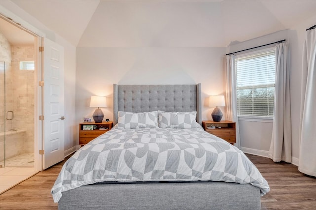 108 Windgate Dr, Hutto, TX 78634 - bedroom featuring vaulted ceiling, wood finished floors, baseboards, and ensuite bathroom