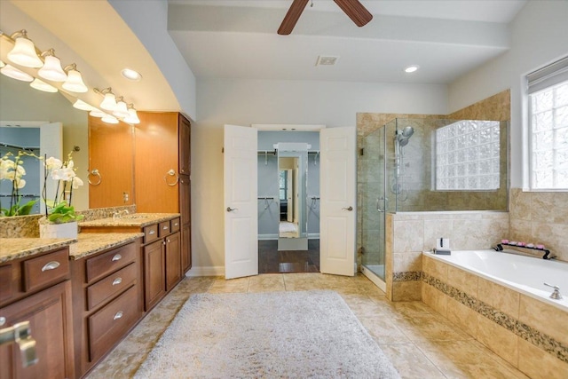 10524 Roy Butler Dr, Austin, TX 78717 - full bath featuring a shower stall, vanity, a garden tub, tile patterned floors, and ceiling fan