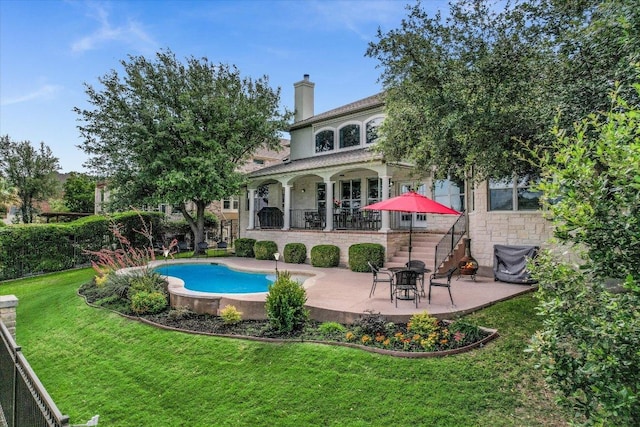 10524 Roy Butler Dr, Austin, TX 78717 - rear view of property with stone siding, a patio, a chimney, a lawn, and an outdoor pool