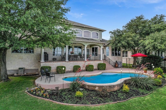 10524 Roy Butler Dr, Austin, TX 78717 - rear view of property featuring stone siding and a patio