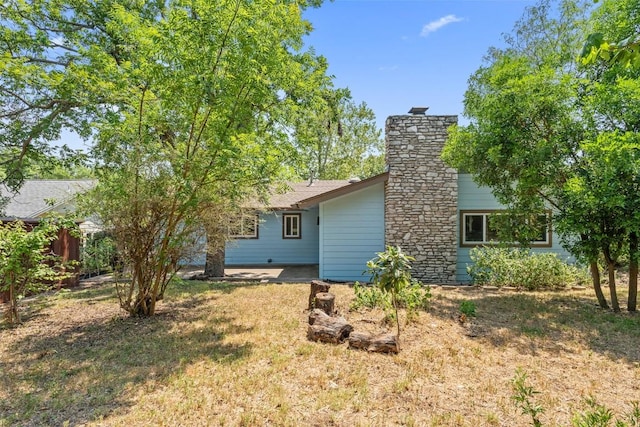 1012 Chesapeake Dr, Austin, TX 78758 - back of house with a chimney