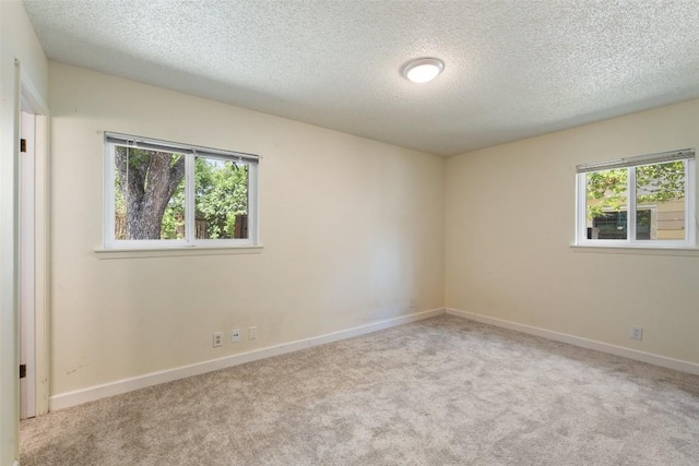 1012 Chesapeake Dr, Austin, TX 78758 - spare room featuring a textured ceiling, carpet, and baseboards