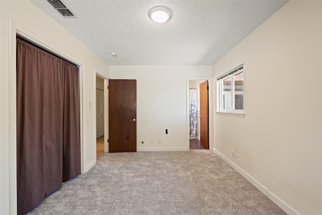 1012 Chesapeake Dr, Austin, TX 78758 - unfurnished bedroom with a closet, a textured ceiling, carpet, and baseboards