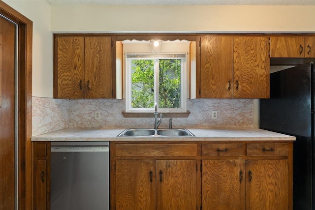 1012 Chesapeake Dr, Austin, TX 78758 - kitchen with stainless steel dishwasher, freestanding refrigerator, a sink, and light countertops