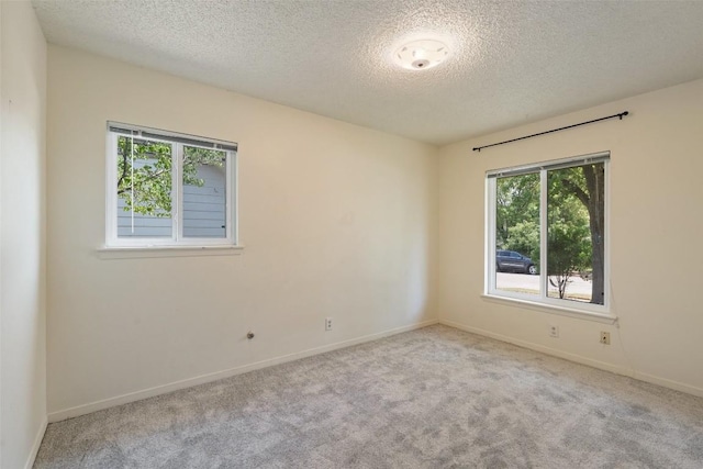 1012 Chesapeake Dr, Austin, TX 78758 - carpeted empty room with a textured ceiling, healthy amount of natural light, and baseboards