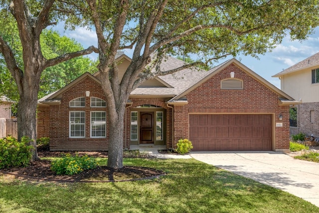 14943 Doria Dr, Austin, TX 78728 - view of front facade featuring brick siding, an attached garage, concrete driveway, a front yard, and roof with shingles