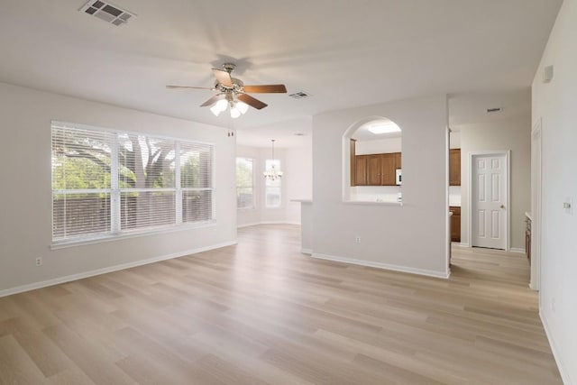 14943 Doria Dr, Austin, TX 78728 - unfurnished living room with a ceiling fan, light wood-style floors, a chandelier, and baseboards