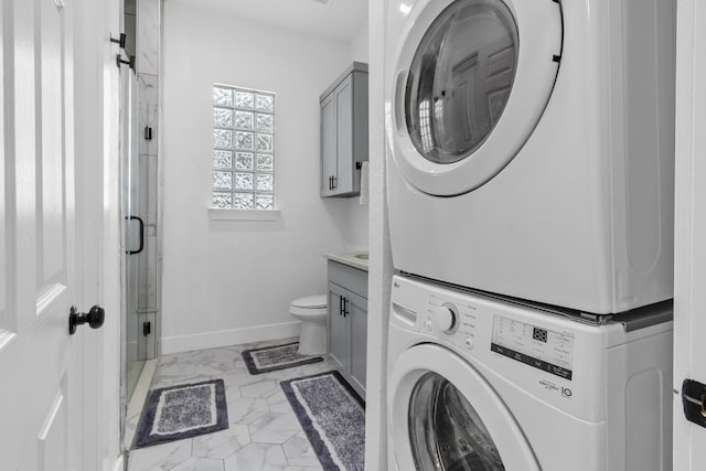 123 Zacate St, Elgin, TX 78621 - laundry room with stacked washing machine and dryer and light marble finish flooring