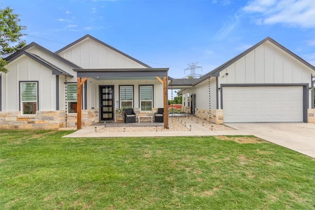123 Zacate St, Elgin, TX 78621 - view of front of house with board and batten siding, stone siding, concrete driveway, and an attached garage