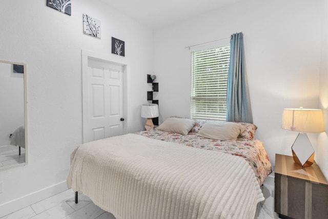 123 Zacate St, Elgin, TX 78621 - bedroom with baseboards and marble look tile flooring