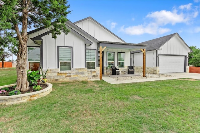 123 Zacate St, Elgin, TX 78621 - modern farmhouse featuring board and batten siding, a garage, and a front lawn