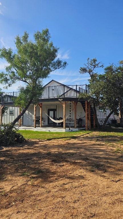 123 Zacate St, Elgin, TX 78621 - back of property with stairs and a deck