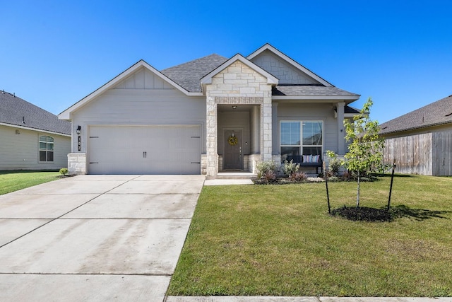 107 Nathaniel Dr, Taylor, TX 76574 - view of front facade featuring a garage, concrete driveway, a shingled roof, a front lawn, and stone siding