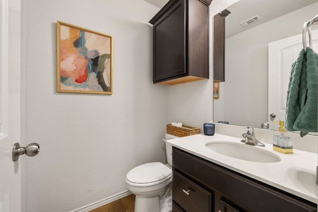 107 Nathaniel Dr, Taylor, TX 76574 - half bath with vanity, toilet, wood finished floors, and baseboards