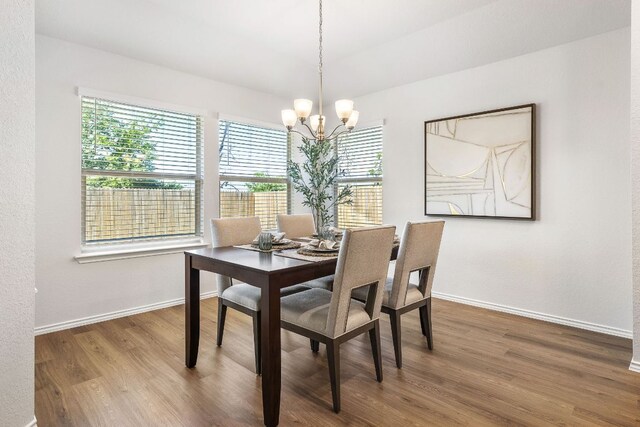 107 Nathaniel Dr, Taylor, TX 76574 - dining space featuring wood finished floors, a chandelier, and baseboards