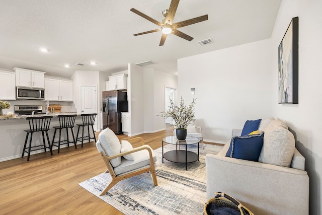 107 Nathaniel Dr, Taylor, TX 76574 - living area with ceiling fan, light wood-type flooring, baseboards, and recessed lighting