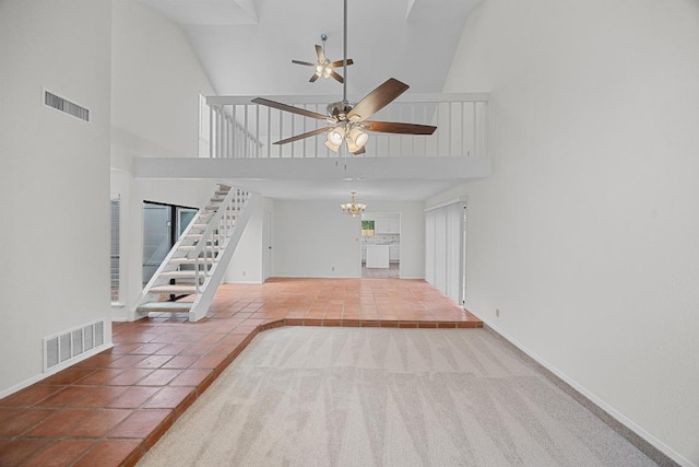 5225 Langwood Dr, Austin, TX 78754 - unfurnished living room featuring high vaulted ceiling, ceiling fan, stairs, tile patterned floors, and a chandelier