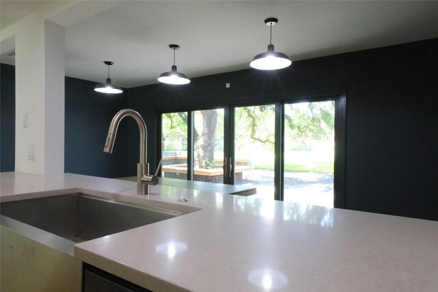808 Vanguard St, Austin, TX 78734 - kitchen featuring a sink, light countertops, and hanging light fixtures