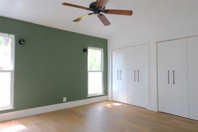 808 Vanguard St, Austin, TX 78734 - unfurnished bedroom with multiple closets, wood finished floors, lofted ceiling, and a ceiling fan