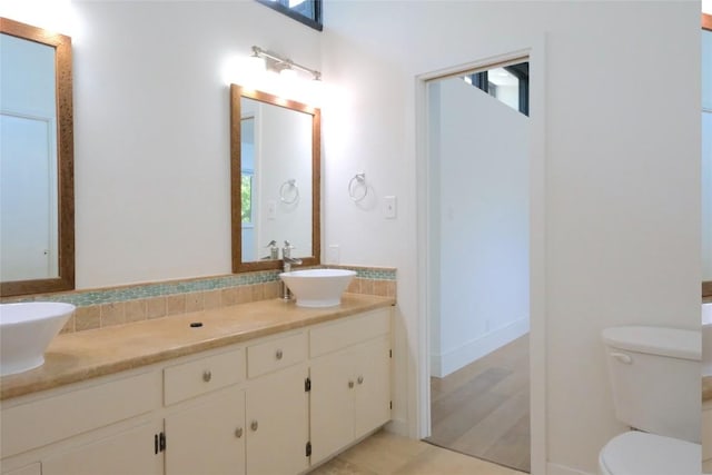 808 Vanguard St, Lakeway, TX 78734 - full bath featuring double vanity, healthy amount of natural light, tile patterned flooring, and decorative backsplash