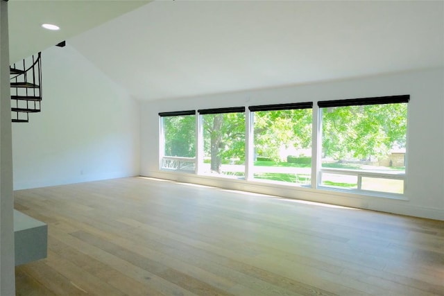 808 Vanguard St, Austin, TX 78734 - unfurnished living room featuring wood finished floors, lofted ceiling, baseboards, and recessed lighting