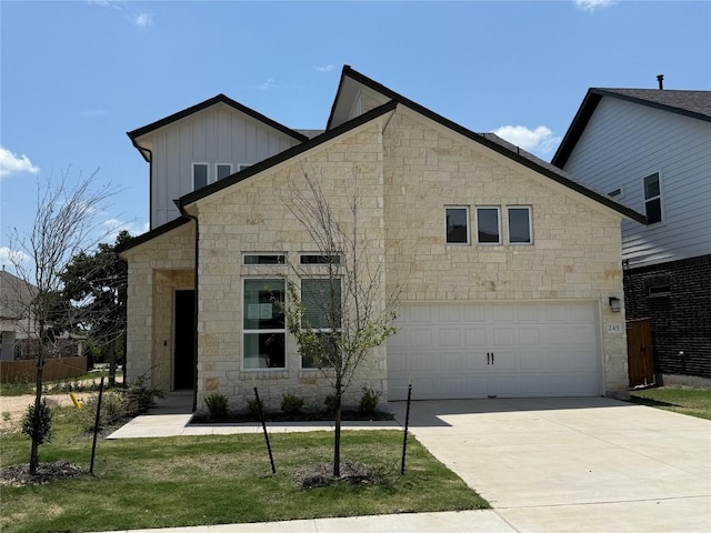 245 Darley Oak Dr, Dripping Springs, TX 78620 - view of front of house featuring board and batten siding, stone siding, a garage, concrete driveway, and a front lawn