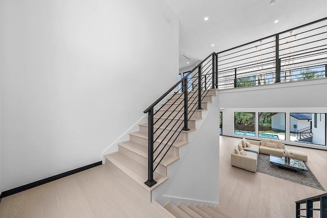 101 S Lake Hills Dr, Austin, TX 78733 - stairs with wood finished floors, a towering ceiling, and recessed lighting