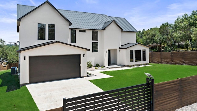 101 S Lake Hills Dr, Austin, TX 78733 - view of front of house featuring a standing seam roof, stucco siding, a metal roof, driveway, and a garage