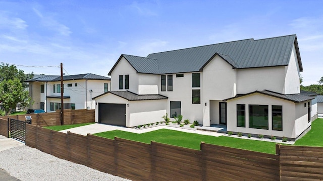 101 S Lake Hills Dr, Austin, TX 78733 - modern inspired farmhouse with stucco siding, metal roof, a standing seam roof, concrete driveway, and an attached garage