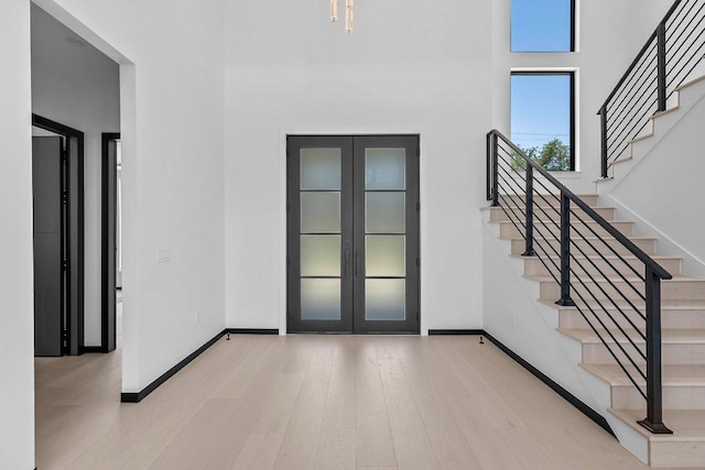 101 S Lake Hills Dr, Austin, TX 78733 - foyer with french doors, wood finished floors, stairs, baseboards, and a high ceiling