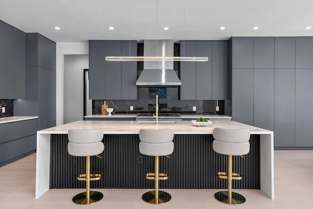 101 S Lake Hills Dr, Austin, TX 78733 - kitchen featuring modern cabinets, wall chimney exhaust hood, gray cabinetry, decorative backsplash, and recessed lighting