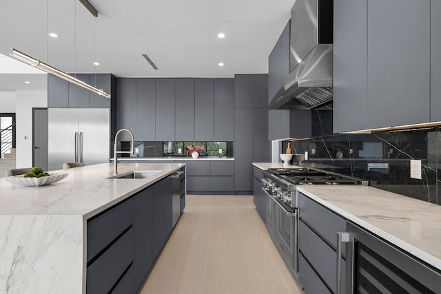101 S Lake Hills Dr, Austin, TX 78733 - kitchen with modern cabinets, wine cooler, wall chimney exhaust hood, high end stainless steel range, and recessed lighting