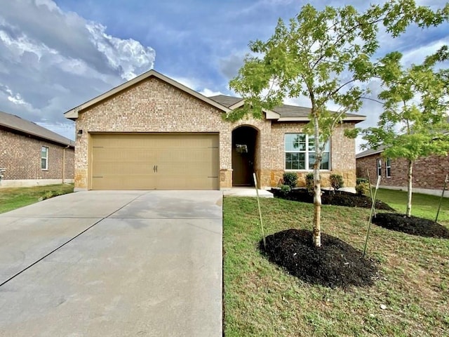 2721 Bridekirk Dr, Round Rock, TX 78664 - single story home featuring an attached garage, driveway, a front yard, and brick siding