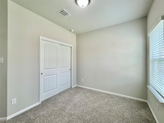 2721 Bridekirk Dr, Round Rock, TX 78664 - unfurnished bedroom with carpet flooring, multiple windows, and baseboards