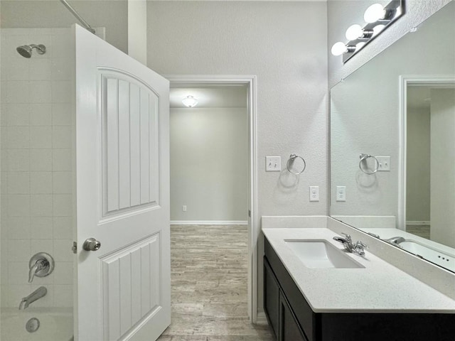 2721 Bridekirk Dr, Round Rock, TX 78664 - full bathroom featuring vanity, wood finished floors, washtub / shower combination, and baseboards