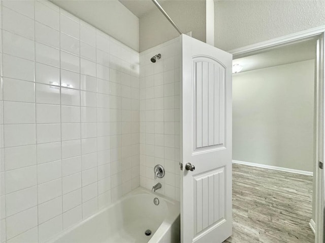 2721 Bridekirk Dr, Round Rock, TX 78664 - bathroom with bathtub / shower combination, wood finished floors, and baseboards