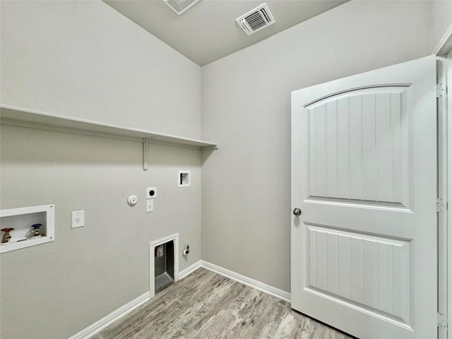 2721 Bridekirk Dr, Round Rock, TX 78664 - washroom with gas dryer hookup, washer hookup, electric dryer hookup, and light wood-style floors