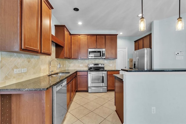 204 Chickadee Ln, Leander, TX 78641 - kitchen with stainless steel appliances, a sink, light tile patterned floors, tasteful backsplash, and dark stone countertops