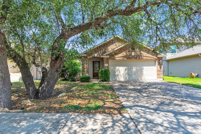 204 Chickadee Ln, Leander, TX 78641 - view of front of house featuring an attached garage, driveway, and brick siding