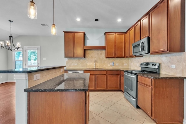 204 Chickadee Ln, Leander, TX 78641 - kitchen featuring appliances with stainless steel finishes, a sink, a chandelier, brown cabinets, and recessed lighting