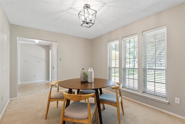 12701 Poquoson Dr, Austin, TX 78727 - dining room with carpet floors, baseboards, a textured ceiling, and a chandelier