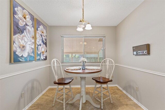 12701 Poquoson Dr, Austin, TX 78727 - dining room featuring a chandelier, a textured ceiling, and baseboards