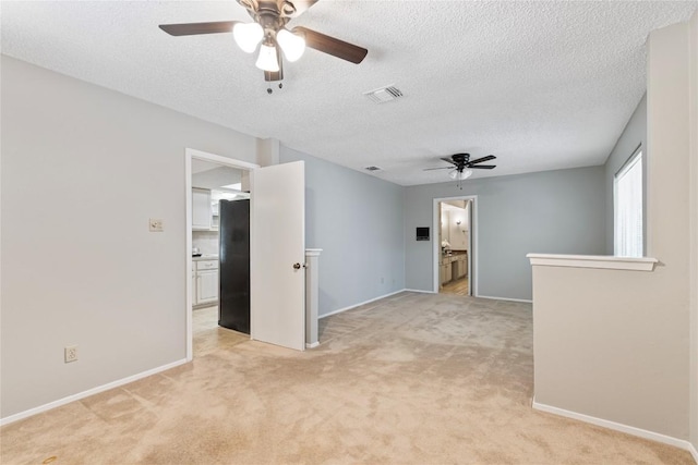 12701 Poquoson Dr, Austin, TX 78727 - unfurnished room with ceiling fan, light carpet, baseboards, and a textured ceiling