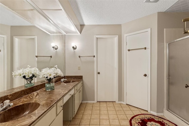 12701 Poquoson Dr, Austin, TX 78727 - bathroom with a stall shower, double vanity, tile patterned floors, baseboards, and a textured ceiling