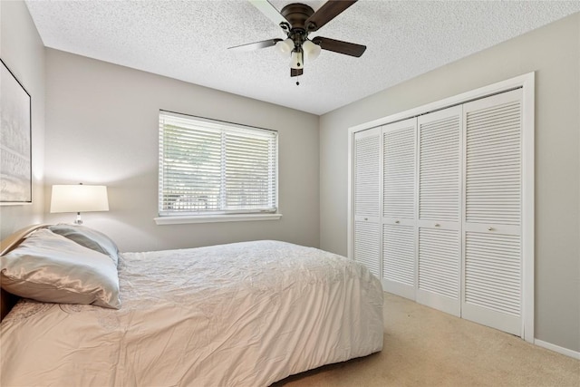 12701 Poquoson Dr, Austin, TX 78727 - bedroom with carpet, a closet, a textured ceiling, and ceiling fan