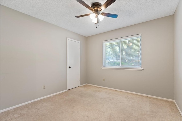 12701 Poquoson Dr, Austin, TX 78727 - empty room featuring light colored carpet, a ceiling fan, baseboards, and a textured ceiling