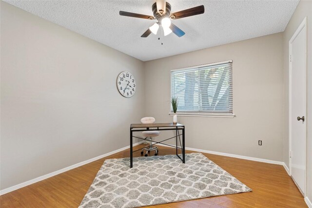 12701 Poquoson Dr, Austin, TX 78727 - office with wood finished floors, a textured ceiling, ceiling fan, and baseboards
