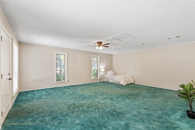 12701 Poquoson Dr, Austin, TX 78727 - unfurnished bedroom featuring a textured ceiling, a ceiling fan, carpet, and attic access