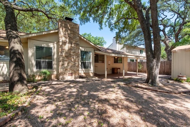 12701 Poquoson Dr, Austin, TX 78727 - back of property with a chimney and a patio