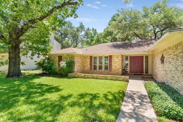 12701 Poquoson Dr, Austin, TX 78727 - view of front of home featuring brick siding, a front lawn, and french doors
